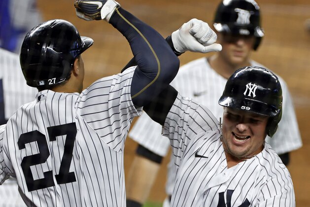 New York Yankees' Luke Voit celebrates hitting a three-run home run with Giancarlo Stanton (27) during the first inning of a baseball game against the Toronto Blue Jays on Tuesday, Sept. 15, 2020, in New York. (AP Photo/Adam Hunger)