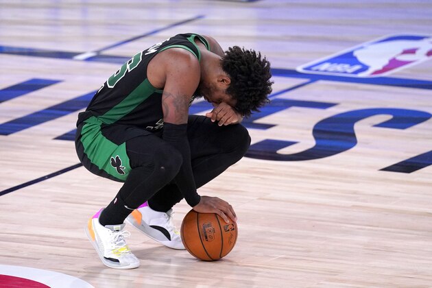Boston Celtics' Marcus Smart reacts after being hit in the face by Toronto Raptors' Pascal Siakam during the first half of an NBA conference semifinal playoff basketball game Friday, Sept. 11, 2020, in Lake Buena Vista, Fla. (AP Photo/Mark J. Terrill)