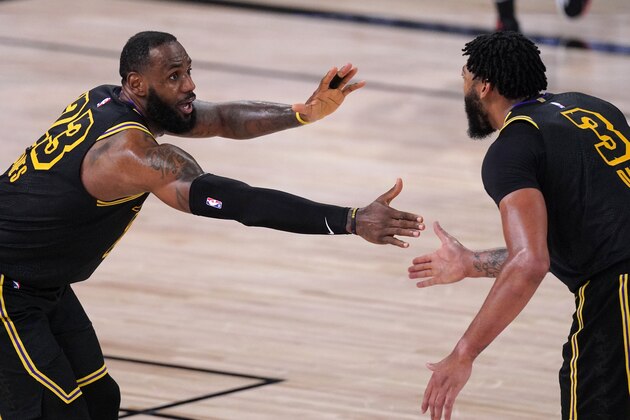 Los Angeles Lakers' LeBron James (23) celebrates with Anthony Davis during the second half of an NBA conference semifinal playoff basketball game against the Houston Rockets Sunday, Sept. 6, 2020, in Lake Buena Vista, Fla. The Lakers won 117-109.(AP Photo/Mark J. Terrill)