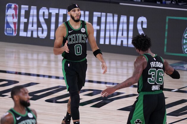 Boston Celtics' Jayson Tatum (0), Marcus Smart (36) and Brad Wanamaker, bottom left, celebrate a basket against the Miami Heat during the first half of an NBA conference final playoff basketball game, Thursday, Sept. 17, 2020, in Lake Buena Vista, Fla. (AP Photo/Mark J. Terrill) Boston Celtics' Jayson Tatum (0), Marcus Smart (36) and Brad Wanamaker, bottom left, celebrate a basket against the Miami Heat during the first half of an NBA conference final playoff basketball game, Thursday, Sept. 17, 2020, in Lake Buena Vista, Fla. (AP Photo/Mark J. Terrill)