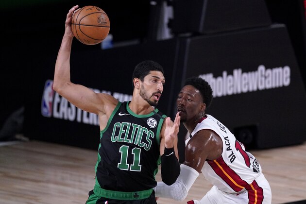 Boston Celtics center Enes Kanter (11) works against Miami Heat forward Bam Adebayo, right, during the first half of an NBA conference final playoff basketball game, Thursday, Sept. 17, 2020, in Lake Buena Vista, Fla. (AP Photo/Mark J. Terrill)