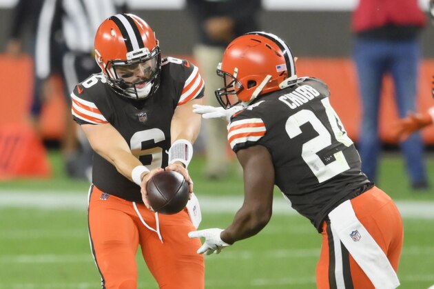 Cleveland Browns quarterback Baker Mayfield (6) hands the ball to running back Nick Chubb (24) during the first half of an NFL football game against the Cincinnati Bengals, Thursday, Sept. 17, 2020, in Cleveland. (AP Photo/David Richard)