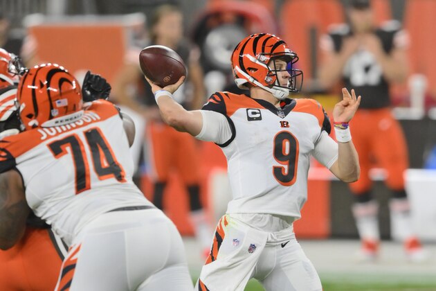 Cincinnati Bengals quarterback Joe Burrow throws a 23-yard touchdown pass to tight end C.J. Uzomah during the first half of an NFL football game against the Cleveland Browns, Thursday, Sept. 17, 2020, in Cleveland. The touchdown pass was the first one of Burrow's career.  (AP Photo/David Richard)