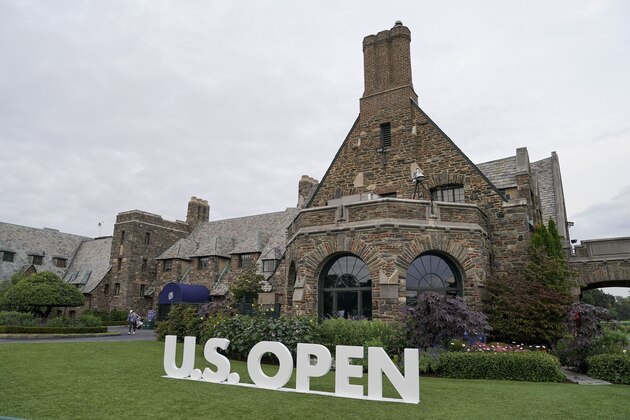 Golfers walk out of the club house at Winged Foot Golf Club during the first round of the US Open Golf Championship, Thursday, Sept. 17, 2020, in Mamaroneck, N.Y. (AP Photo/John Minchillo)