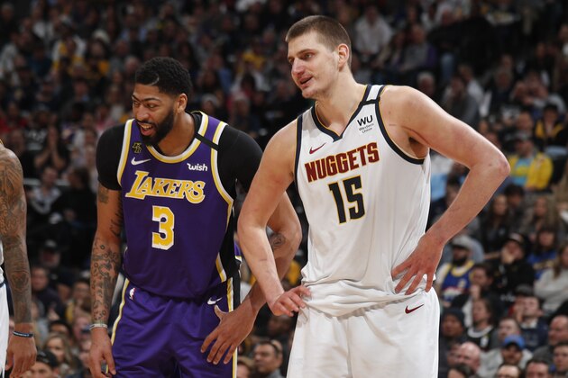 Los Angeles Lakers forward Anthony Davis (3) jokes with Denver Nuggets center Nikola Jokic (15) in the second half of an NBA basketball game Wednesday, Feb. 12, 2020, in Denver. The Lakers won 120-116 in overtime. (AP Photo/David Zalubowski)