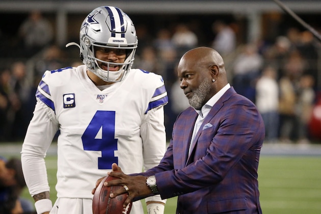 Dallas Cowboys quarterback Dak Prescott (4) talks with former player Emmitt Smith, right, during warmups before an NFL football game against the Buffalo Bills in Arlington, Texas, Thursday, Nov. 28, 2019. (AP Photo/Ron Jenkins)