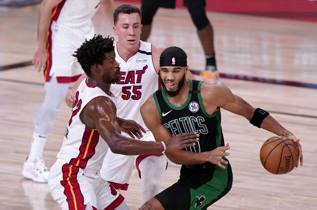 Miami Heat's Jimmy Butler, left, and Duncan Robinson (55) defend as Boston Celtics forward Jayson Tatum (0) handles the ball during the first half of an NBA conference final playoff basketball game, Thursday, Sept. 17, 2020, in Lake Buena Vista, Fla. (AP Photo/Mark J. Terrill) Miami Heat's Jimmy Butler, left, and Duncan Robinson (55) defend as Boston Celtics forward Jayson Tatum (0) handles the ball during the first half of an NBA conference final playoff basketball game, Thursday, Sept. 17, 2020, in Lake Buena Vista, Fla. (AP Photo/Mark J. Terrill)