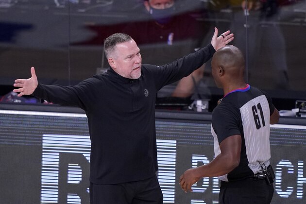 Denver Nuggets head coach Michael Malone argues with referee Courtney Kirkland (61) during the first half an NBA conference final playoff basketball game against the Los Angeles Lakers on Friday, Sept. 18, 2020, in Lake Buena Vista, Fla. (AP Photo/Mark J. Terrill)
