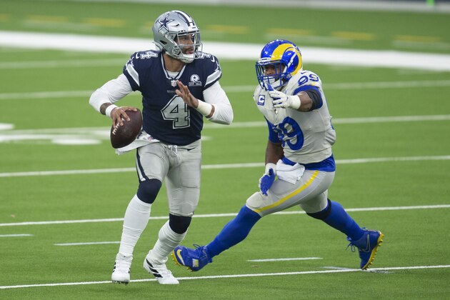 Los Angeles Rams defensive end Aaron Donald, right, chases Dallas Cowboys quarterback Dak Prescott during an NFL football game Sunday, Sept. 13, 2020, in Inglewood, Calif. (AP Photo/Kyusung Gong)