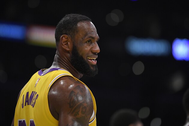 Los Angeles Lakers forward LeBron James smiles as he stands on the court during the first half of an NBA basketball game against the Philadelphia 76ers Tuesday, March 3, 2020, in Los Angeles. (AP Photo/Mark J. Terrill)