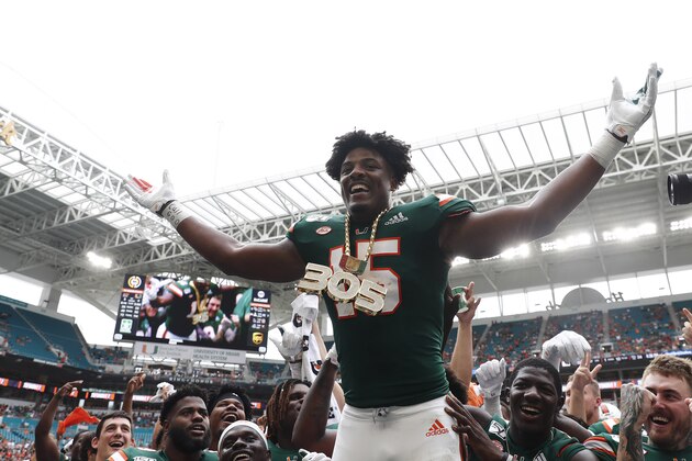 Miami Hurricanes quarterback Jarren Williams (15) celebrates a turn over and wears the turn-over chain during the first half of an NCAA college football game against Central Michigan, Saturday, Sept. 21, 2019, in Miami Gardens, Fla. (AP Photo/Brynn Anderson)