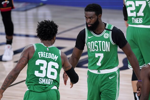 Boston Celtics' Marcus Smart (36) and Jaylen Brown (7) greet each other on the court during the first half of Game 3 of the team's NBA basketball Eastern Conference final final against the Miami Heat, Saturday, Sept. 19, 2020, in Lake Buena Vista, Fla. (AP Photo/Mark J. Terrill)