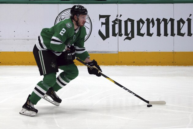 Dallas Stars defenseman Jamie Oleksiak (2) moves the puck down the ice against the Minnesota Wild during an NHL hockey game Friday, Feb. 7, 2020 in Dallas. (AP Photo/Richard W. Rodriguez)