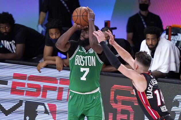Boston Celtics guard Jaylen Brown (7) attempts a 3-point basket as Miami Heat's Tyler Herro (14) defends during the first half of an NBA conference final playoff basketball game, Saturday, Sept. 19, 2020, in Lake Buena Vista, Fla. (AP Photo/Mark J. Terrill)