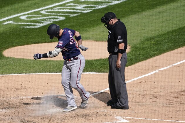 Minnesota Twins' Josh Donaldson kicks dirt on home plate after his home run prompting umpire Dan Bellino to eject him from the game during the sixth inning of a baseball game against the Chicago White Sox Thursday, Sept. 17, 2020, in Chicago. (AP Photo/Charles Rex Arbogast)