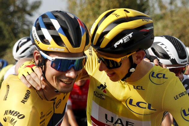 Slovenia's Primoz Roglic, left, who lost his overall leader's yellow jersey to Slovenia's Tadej Pogacar, right, gets a hug during the twenty-first and last stage of the Tour de France cycling race over 122 kilometers (75.8 miles), from Mantes-La-Jolie to Paris, France, Sunday, Sept. 20, 2020. (AP Photo/Christophe Ena)