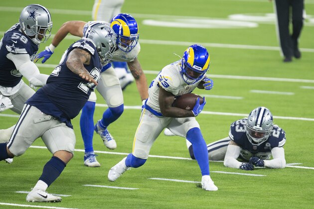 Los Angeles Rams running back Cam Akers, center, finds a hole during an NFL football game against the Dallas Cowboys, Sunday, Sept. 13, 2020, in Inglewood, Calif. (AP Photo/Kyusung Gong)