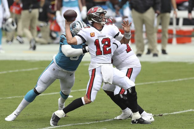 Tampa Bay Buccaneers quarterback Tom Brady (12) throws a touchdown pass to wide receiver Mike Evans during the first half of an NFL football game against the Carolina Panthers Sunday, Sept. 20, 2020, in Tampa, Fla. (AP Photo/Mark LoMoglio)