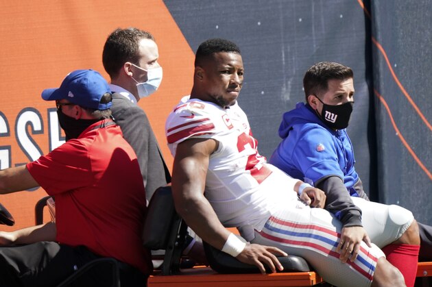 New York Giants running back Saquon Barkley (26) is carted to the locker room after being injured during the first half of an NFL football game against the Chicago Bears in Chicago, Sunday, Sept. 20, 2020. (AP Photo/Nam Y. Huh)