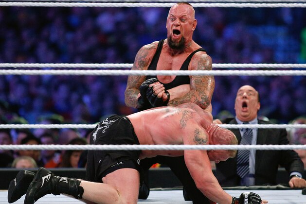 IMAGE DISTRIBUTED FOR WWE - The Undertaker, top, and Brock Lesnar wrestle during Wrestlemania XXX at the Mercedes-Benz Super Dome in New Orleans on Sunday, April 6, 2014. (Jonathan Bachman/AP Images for WWE)