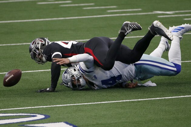 Dallas Cowboys quarterback Dak Prescott (4) fumbles the ball after being sacked by Atlanta Falcons linebacker Deion Jones, top, in the first half of an NFL football game in Arlington, Texas, Sunday, Sept. 20, 2020. (AP Photo/Ron Jenkins)