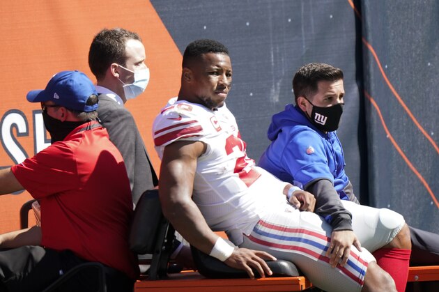 New York Giants running back Saquon Barkley (26) is carted to the locker room after being injured during the first half of an NFL football game against the Chicago Bears in Chicago, Sunday, Sept. 20, 2020. (AP Photo/Nam Y. Huh)