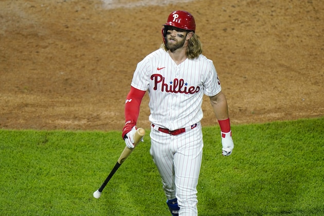 Philadelphia Phillies' Bryce Harper walks to the dugout after lining out against Washington Nationals pitcher Erick Fedde during the fifth inning of a baseball game, Monday, Aug. 31, 2020, in Philadelphia. (AP Photo/Matt Slocum)