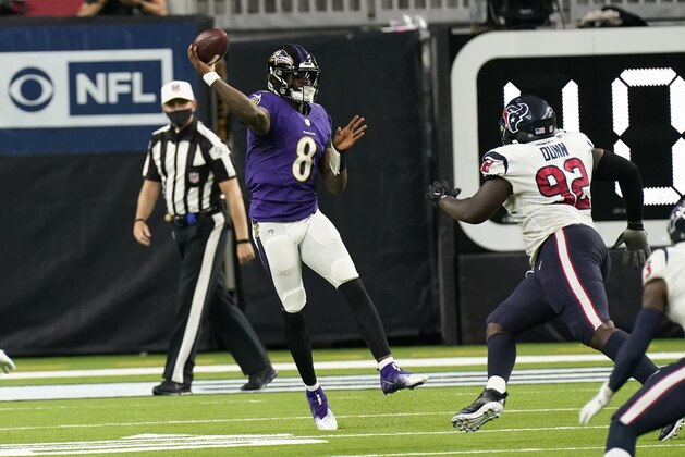 Baltimore Ravens quarterback Lamar Jackson (8) throws a pass over Houston Texans nose tackle Brandon Dunn (92) during the second half of an NFL football game Sunday, Sept. 20, 2020, in Houston. (AP Photo/David J. Phillip)
