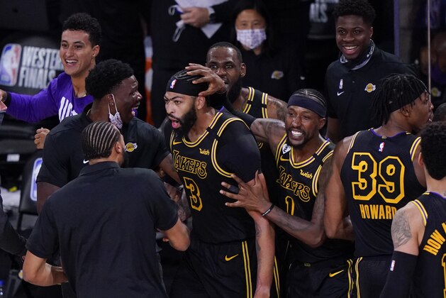 Los Angeles Lakers' Anthony Davis (3) celebrates with teammates after an NBA conference final playoff basketball game against the Denver Nuggets Sunday, Sept. 20, 2020, in Lake Buena Vista, Fla. The Lakers won 105-103. (AP Photo/Mark J. Terrill)