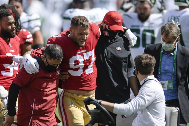 San Francisco 49ers defensive end Nick Bosa (97) is helped off the field after being injured during the first half of an NFL football game against the New York Jets Sunday, Sept. 20, 2020, in East Rutherford, N.J. (AP Photo/Bill Kostroun)