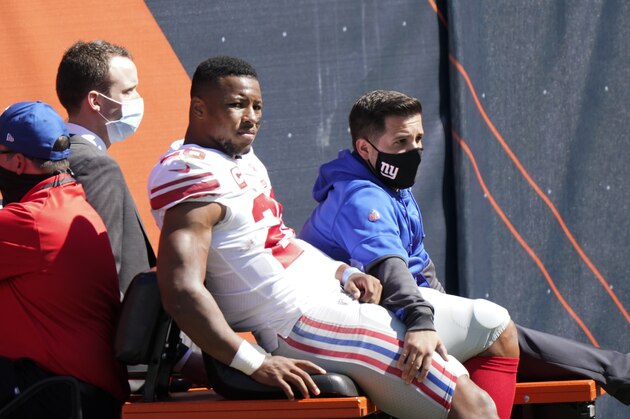 New York Giants running back Saquon Barkley (26) is carted to the locker room after being injured during the first half of an NFL football game against the Chicago Bears in Chicago, Sunday, Sept. 20, 2020. (AP Photo/Nam Y. Huh) New York Giants running back Saquon Barkley (26) is carted to the locker room after being injured during the first half of an NFL football game against the Chicago Bears in Chicago, Sunday, Sept. 20, 2020. (AP Photo/Nam Y. Huh)