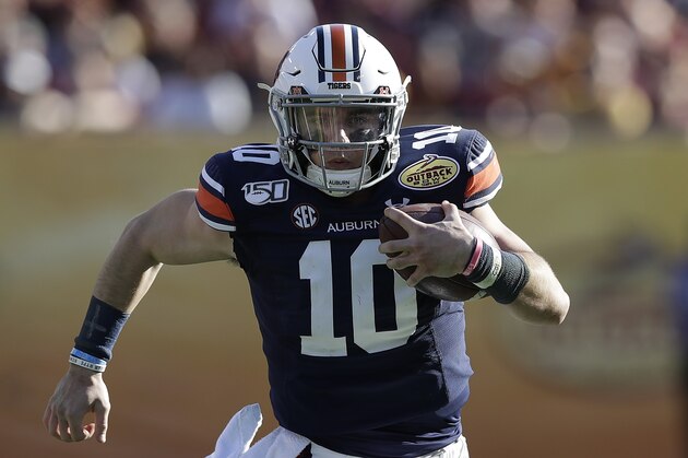 Auburn quarterback Bo Nix runs against Minnesota during the second half of the Outback Bowl NCAA college football game Wednesday, Jan. 1, 2020, in Tampa, Fla. (AP Photo/Chris O'Meara)