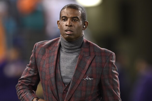 Deion Sanders walks on the field before an NFL football game between the Baltimore Ravens and the Miami Dolphins, Thursday, Oct. 26, 2017, in Baltimore. (AP Photo/Gail Burton)
