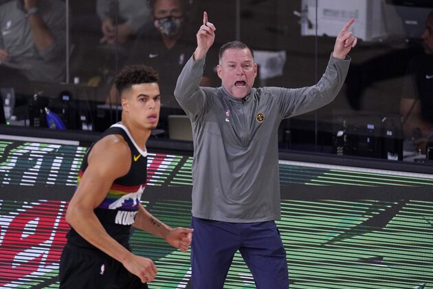 Denver Nuggets head coach Michael Malone instructs the team as forward Michael Porter Jr. (1) runs up court during the second half of Game 3 of the NBA basketball Western Conference final against the Los Angeles Lakers on Tuesday, Sept. 22, 2020, in Lake Buena Vista, Fla. (AP Photo/Mark J. Terrill)