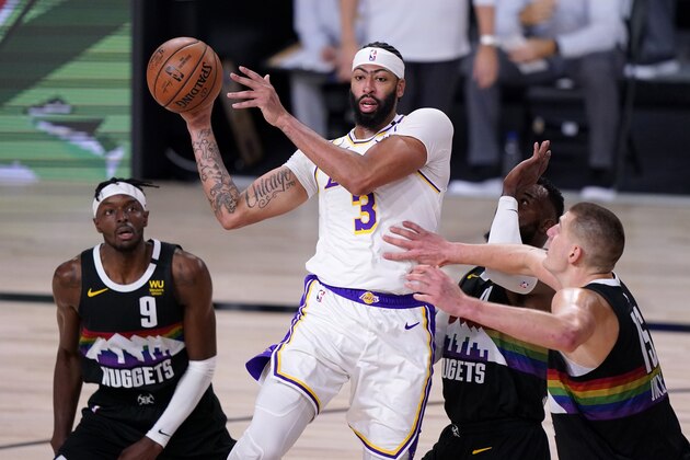 Denver Nuggets' Jerami Grant (9), Paul Millsap, center rear, and Nikola Jokic (15), defend as Los Angeles Lakers' Anthony Davis (3) makes a pass during the first half of Game 3 of the NBA basketball Western Conference final Tuesday, Sept. 22, 2020, in Lake Buena Vista, Fla. (AP Photo/Mark J. Terrill)