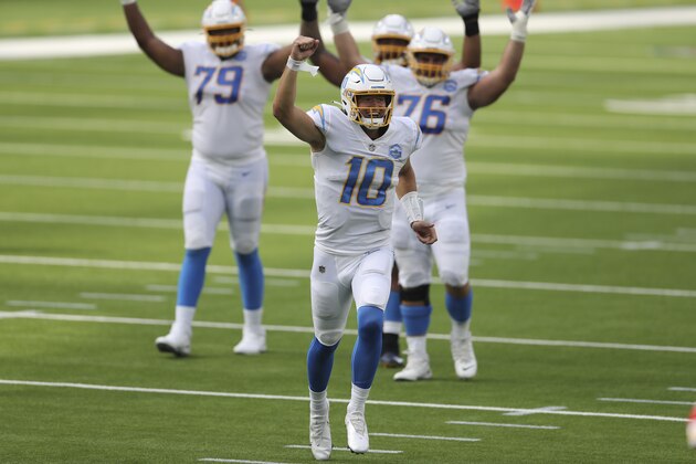Los Angeles Chargers quarterback Justin Herbert (10) celebrates after his first career NFL touchdown pass during an NFL football game between against the Kansas City Chiefs, Sunday, Sept. 20, 2020, in Inglewood, Calif. (AP Photo/Peter Joneleit)