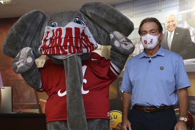 HOLD FOR SATURDAY, MAY 23- In this May 20, 2020 photo provided by the University of Alabama, football head coach Nick Saban and the school's elephant mascot, Big Al, wear masks on the university campus in Tuscaloosa, AL. Health officials are worried that Alabama's coronavirus caseload is increasing and residents aren't guarding against COVID-19 as it opens its casinos, church and more. Saban recorded a video promoting the use of face masks and social distancing. (AP Photo/Kent Gidley, University of Alabama via AP)