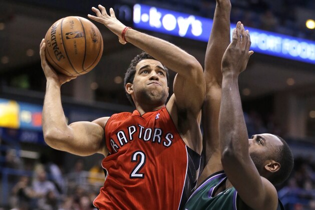 Toronto Raptors' Landry Fields (2) drives against Milwaukee Bucks' Luc Richard Mbah a Moute, right, during the first half of an NBA basketball game Saturday, March 2, 2013, in Milwaukee. (AP Photo/Jeffrey Phelps)