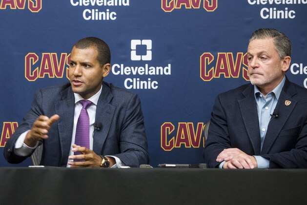 New Cleveland Cavaliers general manager Koby Altman, left, answers a question about Cavaliers Kyrie Irving's demand for a trade, as Cavaliers chairman Dan Gilbert listens during a news conference at the Cavaliers training facility in Independence, Ohio, Wednesday, July 26, 2017. (AP Photo/Phil Long) New Cleveland Cavaliers general manager Koby Altman, left, answers a question about Cavaliers Kyrie Irving's demand for a trade, as Cavaliers chairman Dan Gilbert listens during a news conference at the Cavaliers training facility in Independence, Ohio, Wednesday, July 26, 2017. (AP Photo/Phil Long)