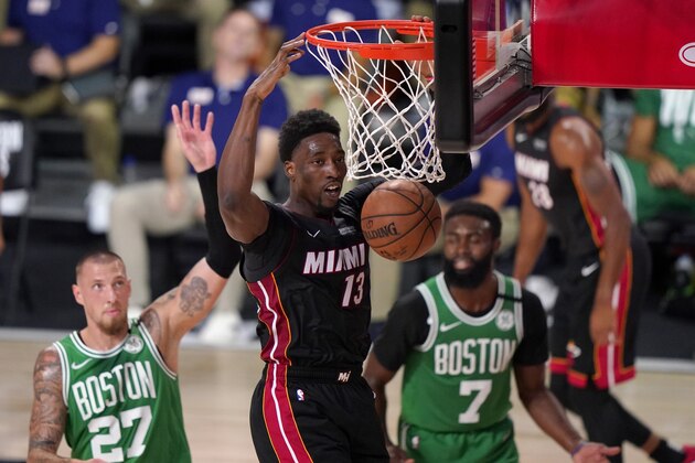 Miami Heat forward Bam Adebayo (13) dunks the ball as Boston Celtics' Daniel Theis (27) and Jaylen Brown (7) look on during the first half of Game 4 of an NBA basketball Eastern Conference final, Wednesday, Sept. 23, 2020, in Lake Buena Vista, Fla. (AP Photo/Mark J. Terrill)