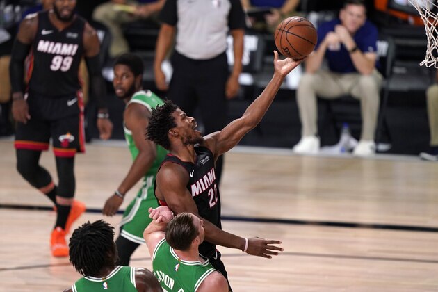 Miami Heat forward Jimmy Butler (22) leaps to the basket for a shot over Boston Celtics' Robert Williams III, bottom left, and Gordon Hayward, bottom center, during the first half of Game 4 of an NBA basketball Eastern Conference final, Wednesday, Sept. 23, 2020, in Lake Buena Vista, Fla. (AP Photo/Mark J. Terrill) Miami Heat forward Jimmy Butler (22) leaps to the basket for a shot over Boston Celtics' Robert Williams III, bottom left, and Gordon Hayward, bottom center, during the first half of Game 4 of an NBA basketball Eastern Conference final, Wednesday, Sept. 23, 2020, in Lake Buena Vista, Fla. (AP Photo/Mark J. Terrill)