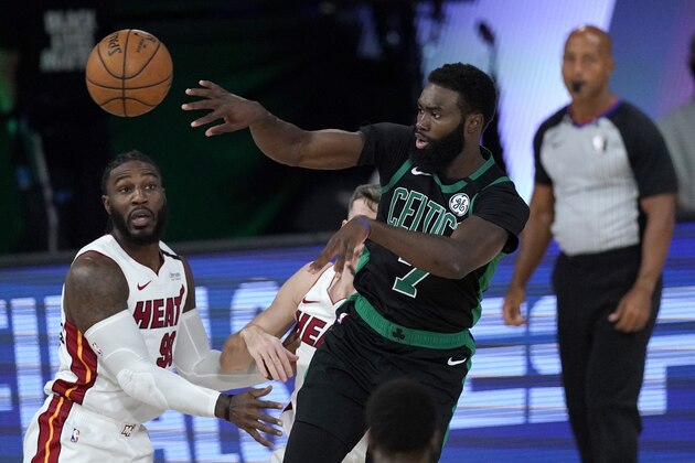 Boston Celtics' Jaylen Brown (7) makes a pass over Miami Heat's Jae Crowder, left, during the first half of an NBA conference final playoff basketball game, Tuesday, Sept. 15, 2020, in Lake Buena Vista, Fla. (AP Photo/Mark J. Terrill)