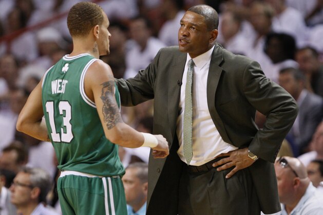 Boston Celtics head coach Doc Rivers, right, talks with Delonte West during the first half of Game 5 of a second-round NBA playoff basketball series against the Miami Heat, Wednesday, May 11, 2011 in Miami. (AP Photo/Wilfredo Lee)
