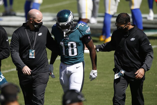 Philadelphia Eagles' Jalen Reagor is helped off the field during the first half of an NFL football game against the Los Angeles Rams, Sunday, Sept. 20, 2020, in Philadelphia. (AP Photo/Laurence Kesterson)