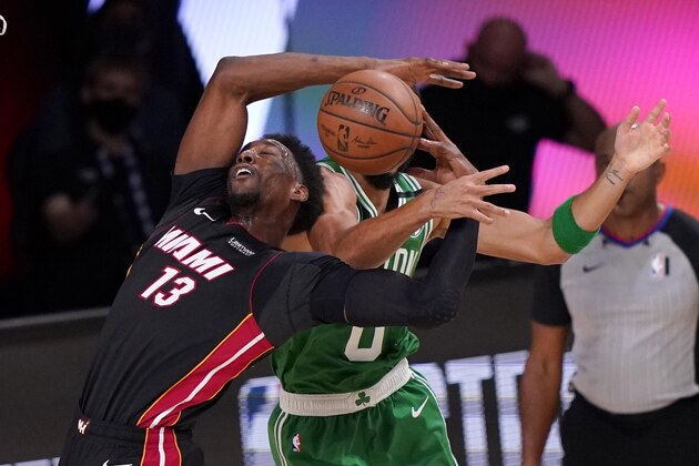 Miami Heat forward Bam Adebayo (13) struggles to maintain control of the ball against Boston Celtics' Jayson Tatum, rear, during the second half of Game 4 of an NBA basketball Eastern Conference final, Wednesday, Sept. 23, 2020, in Lake Buena Vista, Fla. (AP Photo/Mark J. Terrill)
