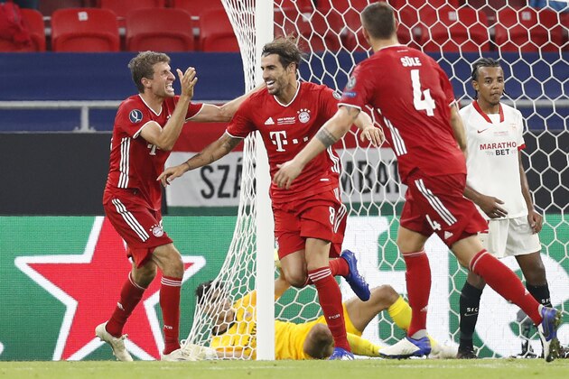 Bayern's Javi Martinez, second from left, celebrates after scoring his side's second goal during the UEFA Super Cup soccer match between Bayern Munich and Sevilla at the Puskas Arena in Budapest, Hungary, Thursday, Sept. 24, 2020. (AP Photo/Laszlo Balogh, Pool)