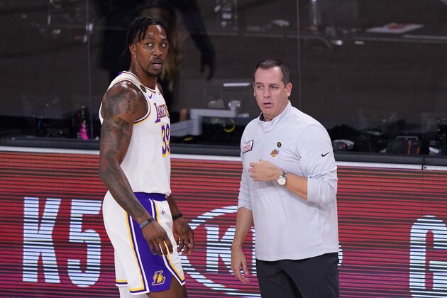 Los Angeles Lakers' Dwight Howard, left, talks with head coach Michael Malone, right, during the first half of Game 3 of the NBA basketball Western Conference final against the Denver Nuggets on Tuesday, Sept. 22, 2020, in Lake Buena Vista, Fla. (AP Photo/Mark J. Terrill)
