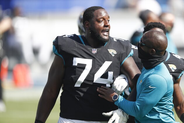 Jacksonville Jaguars offensive tackle Cam Robinson (74) has words with a Tennessee Titans player after an NFL football game Sunday, Sept. 20, 2020, in Nashville, Tenn. (AP Photo/Wade Payne) Jacksonville Jaguars offensive tackle Cam Robinson (74) has words with a Tennessee Titans player after an NFL football game Sunday, Sept. 20, 2020, in Nashville, Tenn. (AP Photo/Wade Payne)