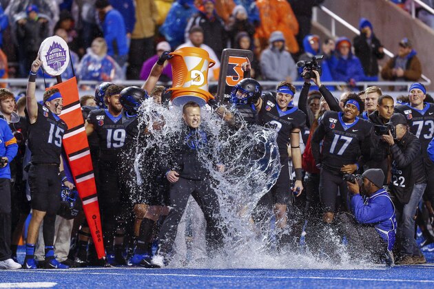 Boise State head coach Bryan Harsin has water dumped on him after winning the Mountain West Championship over Hawaii in a NCAA college football game for the Mountain West Championship Saturday, Dec. 7, 2019, in Boise, Idaho. Boise State won 31-10. (AP Photo/Steve Conner)