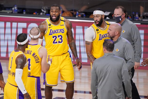 Los Angeles Lakers' LeBron James (23) talks with teammates during a timeout in the second half of an NBA conference final playoff basketball game against the Denver Nuggets Thursday, Sept. 24, 2020, in Lake Buena Vista, Fla. The Lakers won 114-108. (AP Photo/Mark J. Terrill)